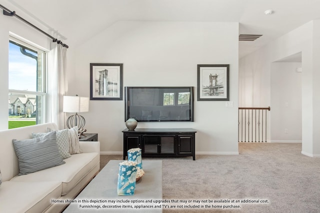 carpeted living room featuring lofted ceiling