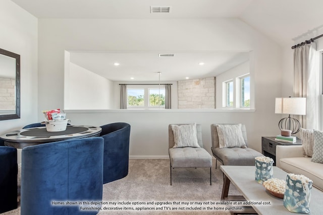 carpeted living room featuring lofted ceiling and a healthy amount of sunlight