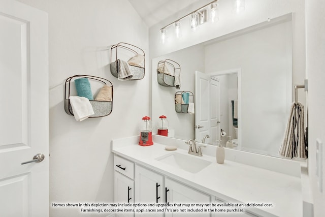 bathroom with toilet and vanity