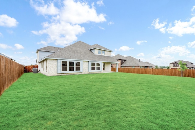 1233 Sylvia St, Desoto, TX 75115 - back of property with central AC, brick siding, and a shingled roof