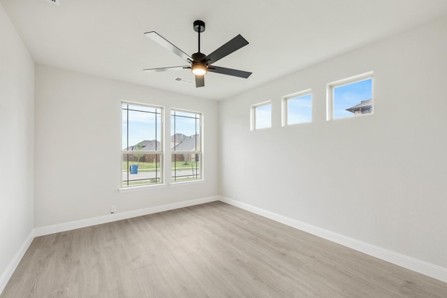 1233 Sylvia St, Desoto, TX 75115 - unfurnished room with light wood finished floors, a ceiling fan, and baseboards
