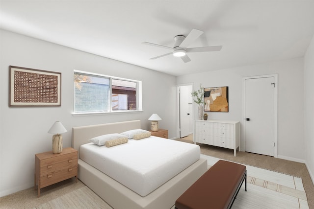 bedroom with light carpet and a ceiling fan