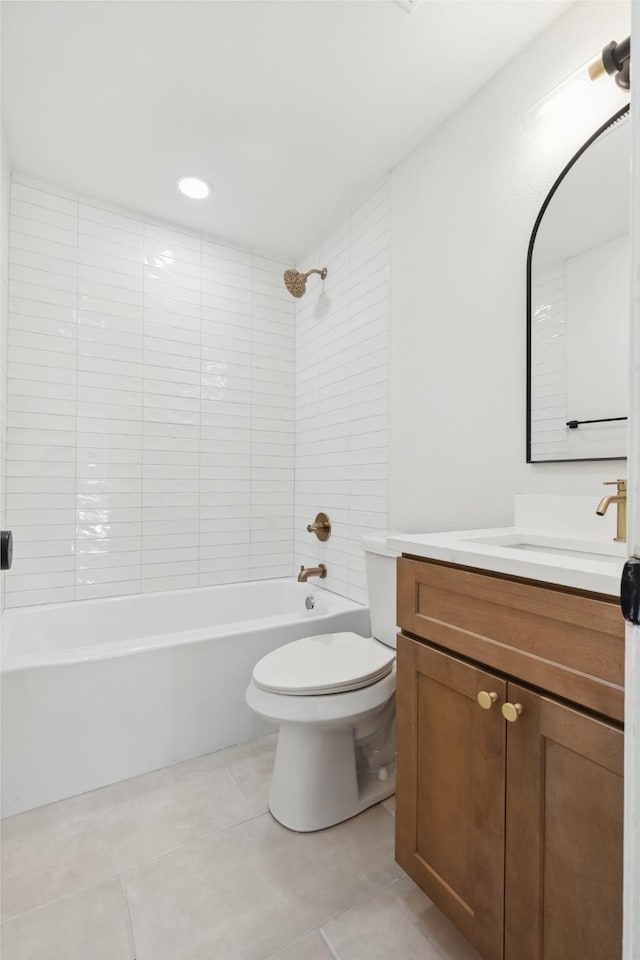 bathroom with tile patterned flooring, toilet, vanity, and shower / washtub combination