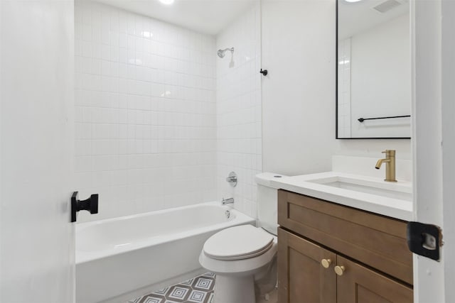 full bathroom featuring toilet, tiled shower / bath, and vanity