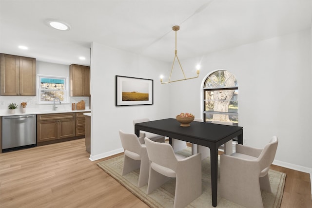 dining room featuring recessed lighting, baseboards, a chandelier, and light wood finished floors