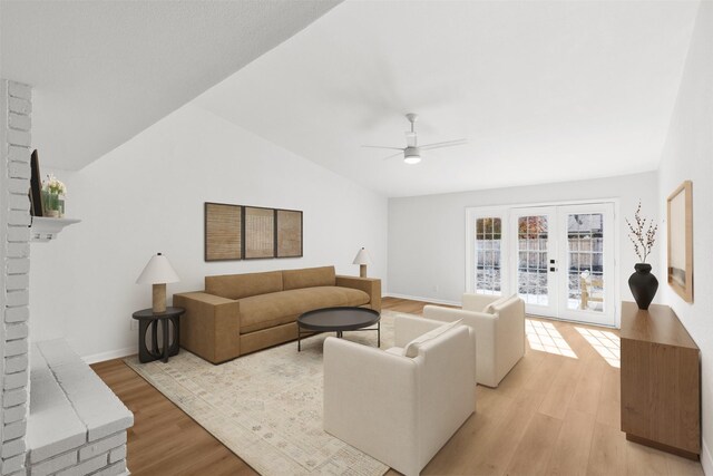 living area with ceiling fan, french doors, light wood-type flooring, and lofted ceiling