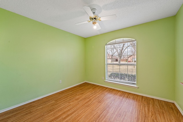 unfurnished room featuring light hardwood / wood-style floors, a textured ceiling, and ceiling fan