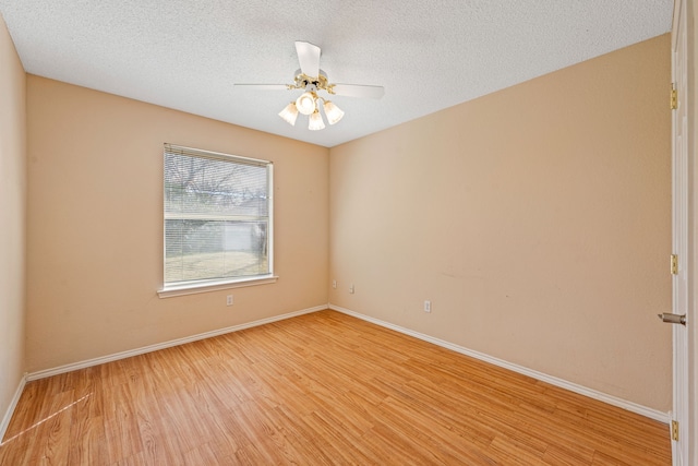 spare room with ceiling fan, a textured ceiling, and light hardwood / wood-style floors