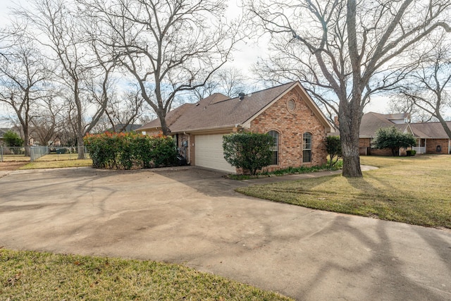 view of side of home featuring a garage and a lawn