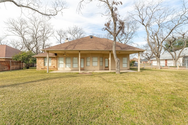 rear view of house with a patio area and a lawn