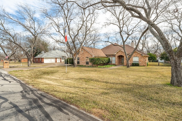 ranch-style home featuring a garage and a front yard