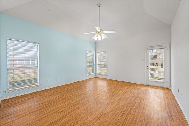 unfurnished room with lofted ceiling, ceiling fan, and light hardwood / wood-style flooring