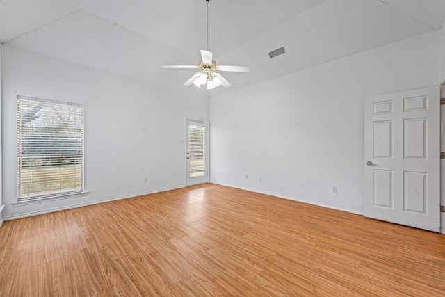 unfurnished room with ceiling fan, lofted ceiling, and light wood-type flooring