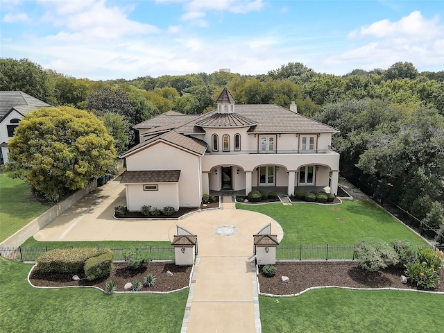 mediterranean / spanish-style house with a front yard