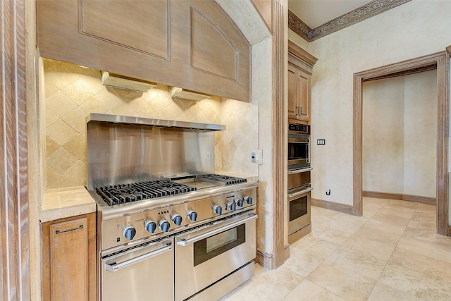 kitchen with ornamental molding, appliances with stainless steel finishes, and backsplash