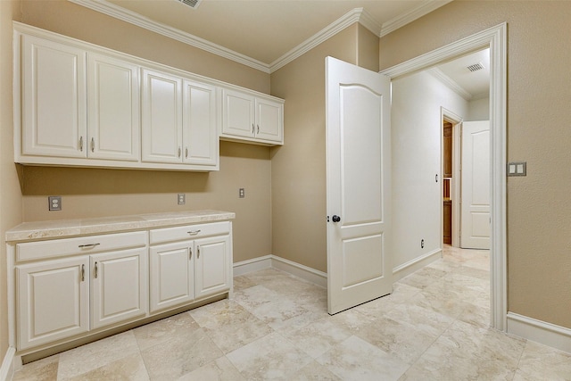 laundry area featuring ornamental molding