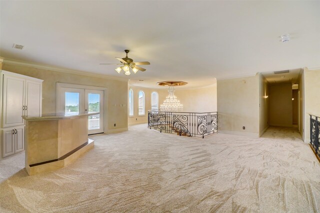 carpeted empty room featuring crown molding and ceiling fan with notable chandelier