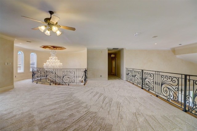 empty room with crown molding, light colored carpet, and a chandelier