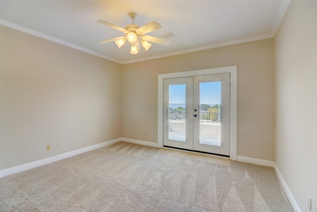 carpeted empty room featuring crown molding, french doors, and ceiling fan