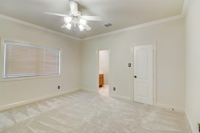 carpeted empty room with ceiling fan and ornamental molding