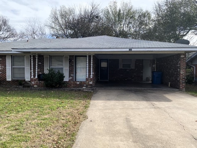 single story home featuring a front lawn and a carport