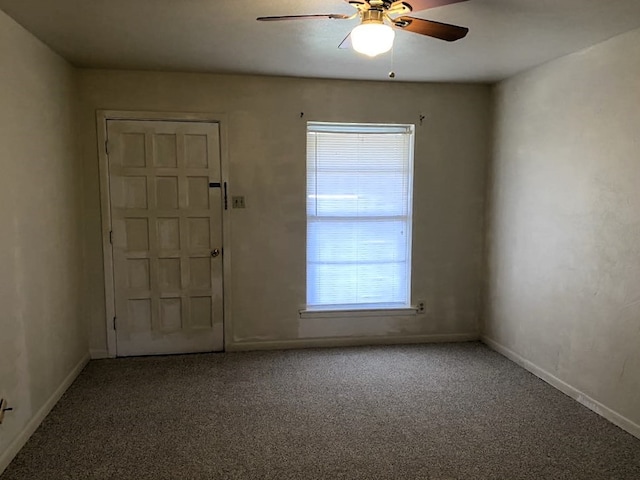 empty room with ceiling fan and carpet flooring