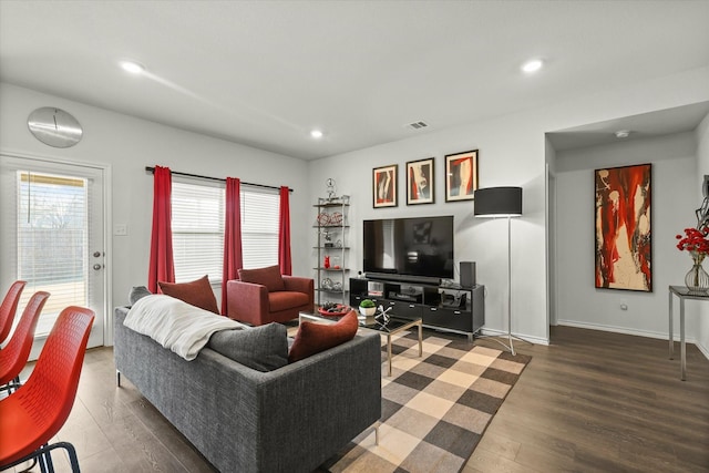 living room with dark hardwood / wood-style flooring