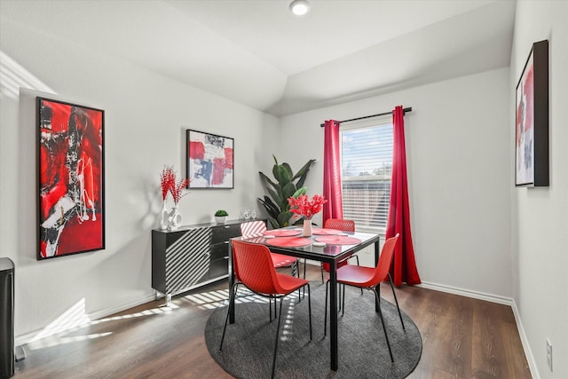 dining area with lofted ceiling and dark hardwood / wood-style floors