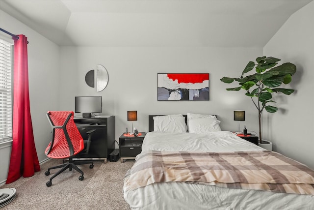 carpeted bedroom with lofted ceiling