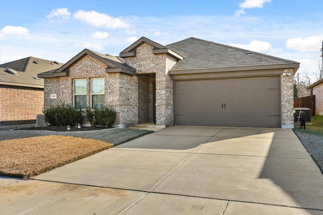 view of front of property with a garage and cooling unit