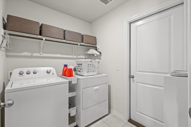 laundry room with light tile patterned floors and independent washer and dryer