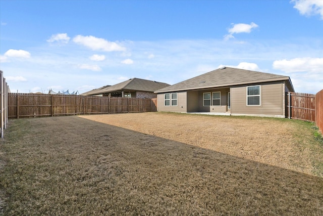 rear view of property featuring a yard