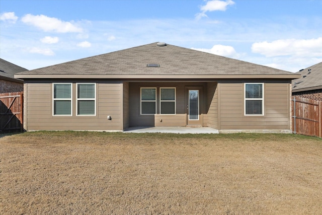 rear view of house featuring a patio area and a lawn