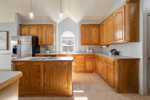 kitchen with a center island, pendant lighting, sink, black stovetop, and light tile patterned floors