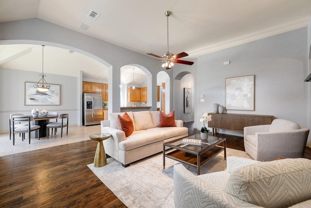 living room featuring ceiling fan, light hardwood / wood-style flooring, and lofted ceiling