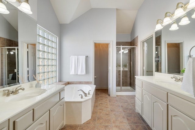 bathroom featuring vaulted ceiling, tile patterned flooring, shower with separate bathtub, and vanity