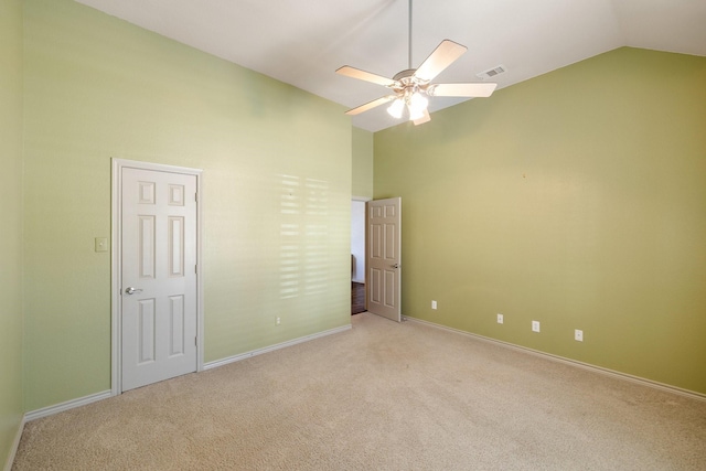 carpeted empty room featuring ceiling fan and lofted ceiling