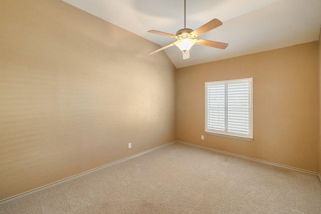 carpeted empty room featuring ceiling fan and vaulted ceiling