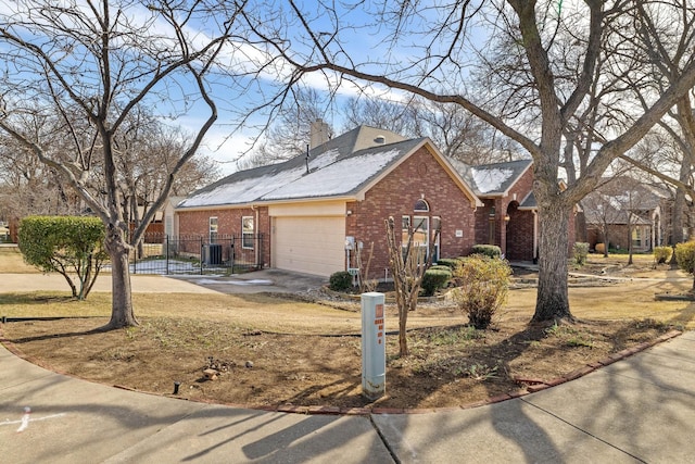 view of front of home featuring a garage and central AC