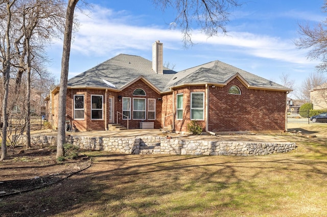 rear view of property featuring a yard and a patio