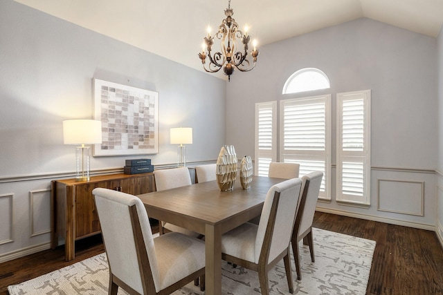 dining room with lofted ceiling, dark hardwood / wood-style flooring, and a chandelier