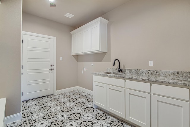 washroom featuring cabinets, hookup for a washing machine, and sink