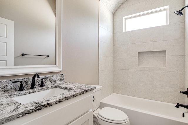 full bathroom with toilet, vanity, and tiled shower / bath