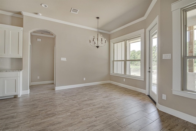 interior space with a chandelier and ornamental molding