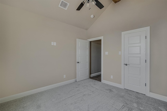 unfurnished bedroom with ceiling fan, light colored carpet, high vaulted ceiling, and beam ceiling