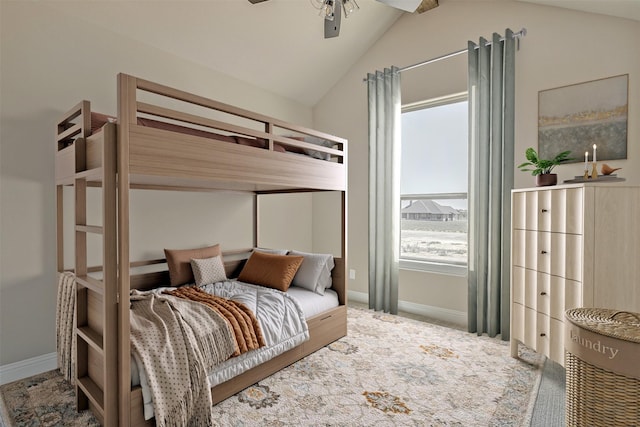 bedroom featuring vaulted ceiling, ceiling fan, and multiple windows