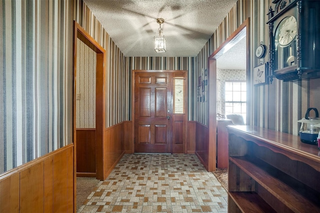 entryway featuring wood walls