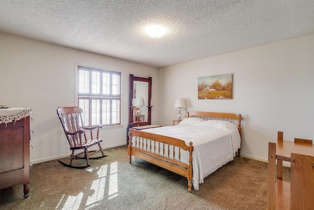 bedroom featuring a textured ceiling and carpet flooring