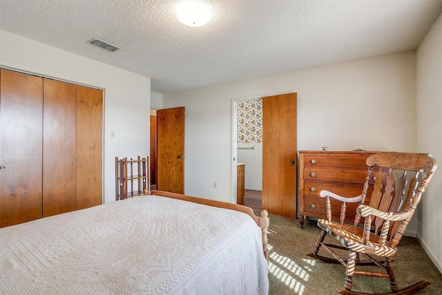 bedroom with carpet floors, a closet, and a textured ceiling