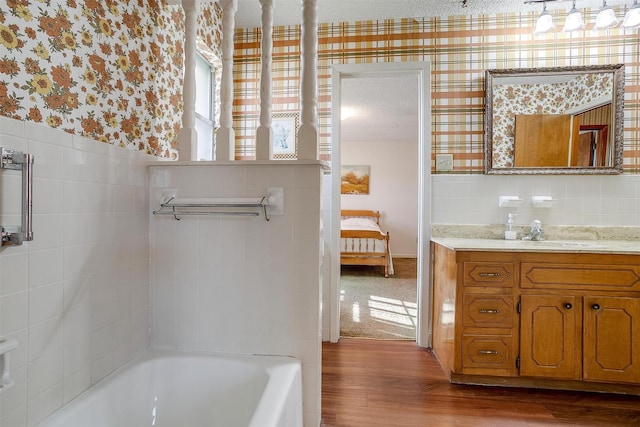 bathroom featuring vanity, a bathing tub, and hardwood / wood-style floors